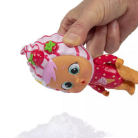 hand holding icy world doll close to snow 