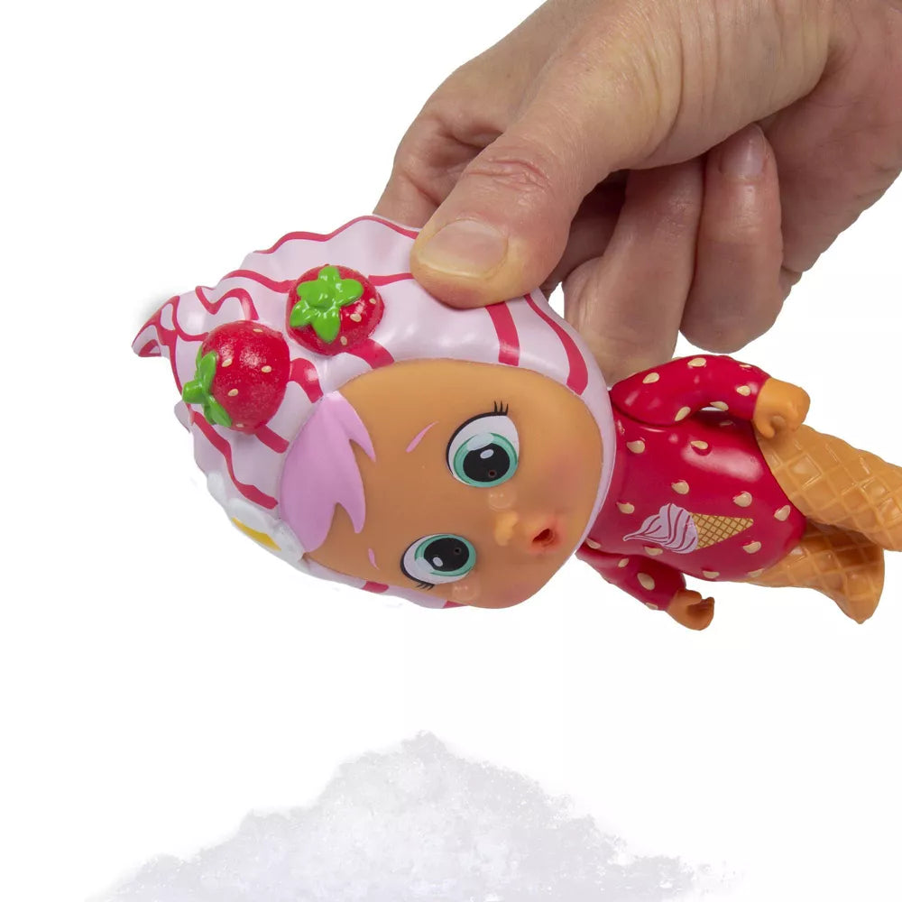hand holding icy world doll close to snow 