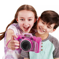 two young kids holding out bright pink kids camera on white background