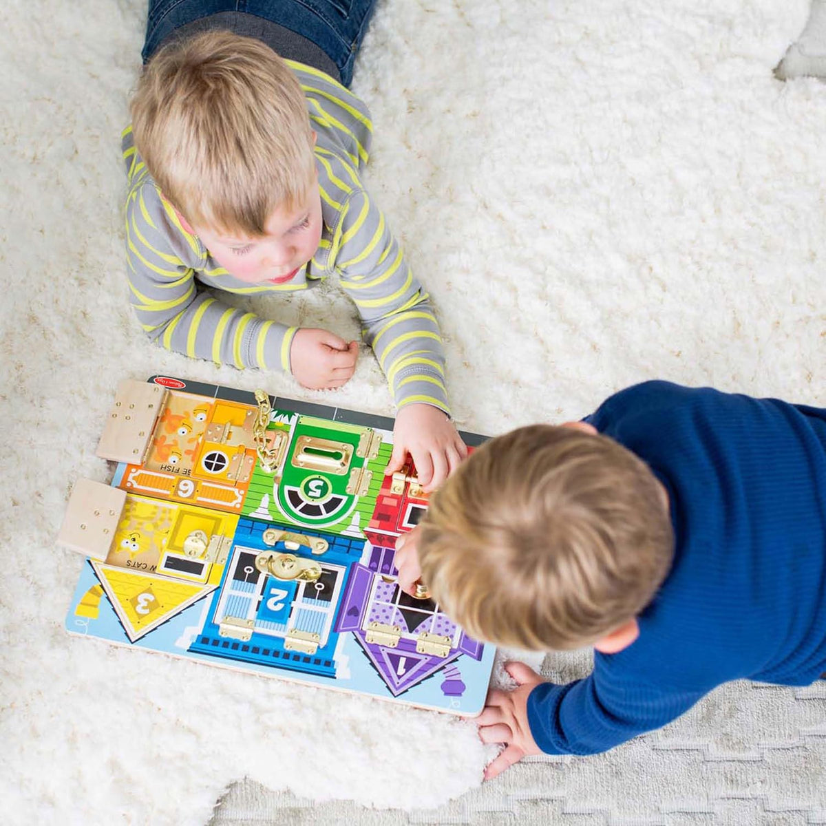 two children playing with wooden latches toy