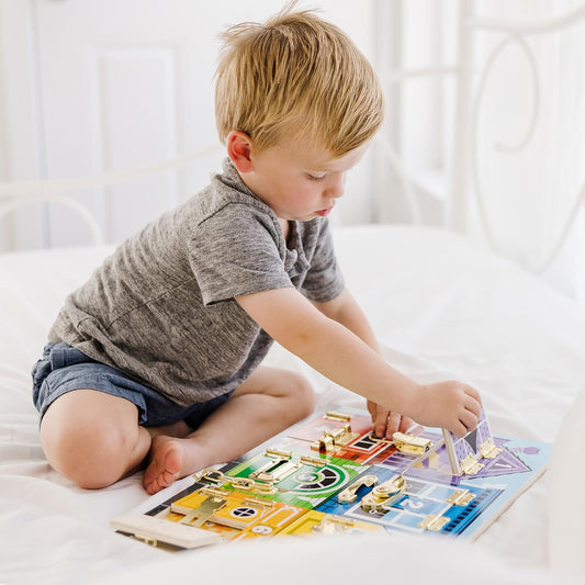 child playing with wooden latches toy 