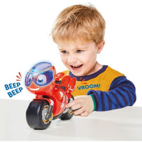 child playing with red motorbike 