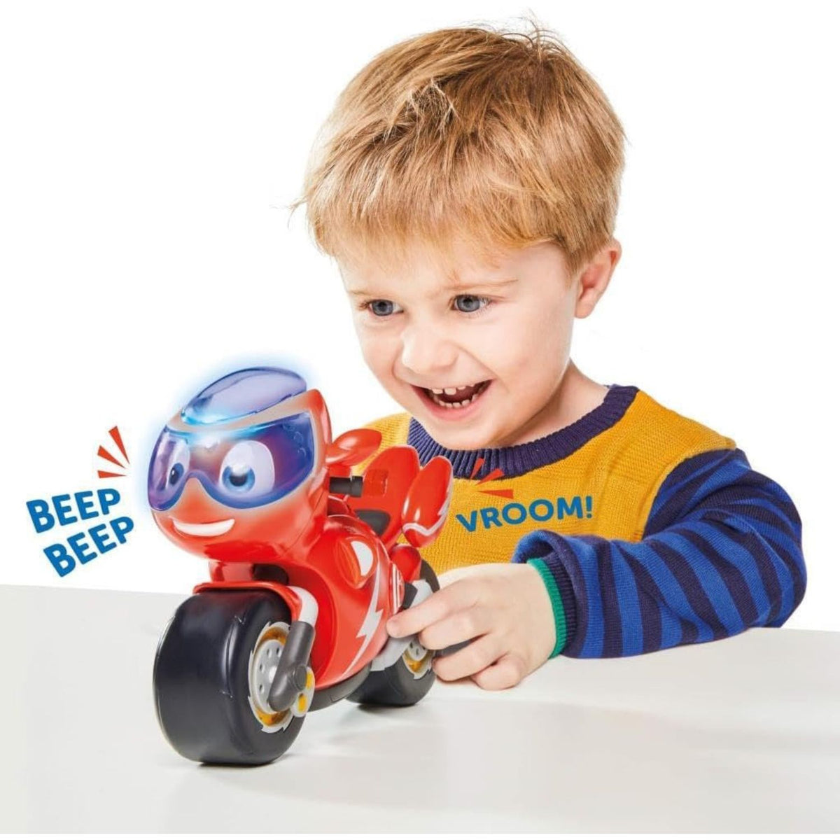 child playing with red motorbike 