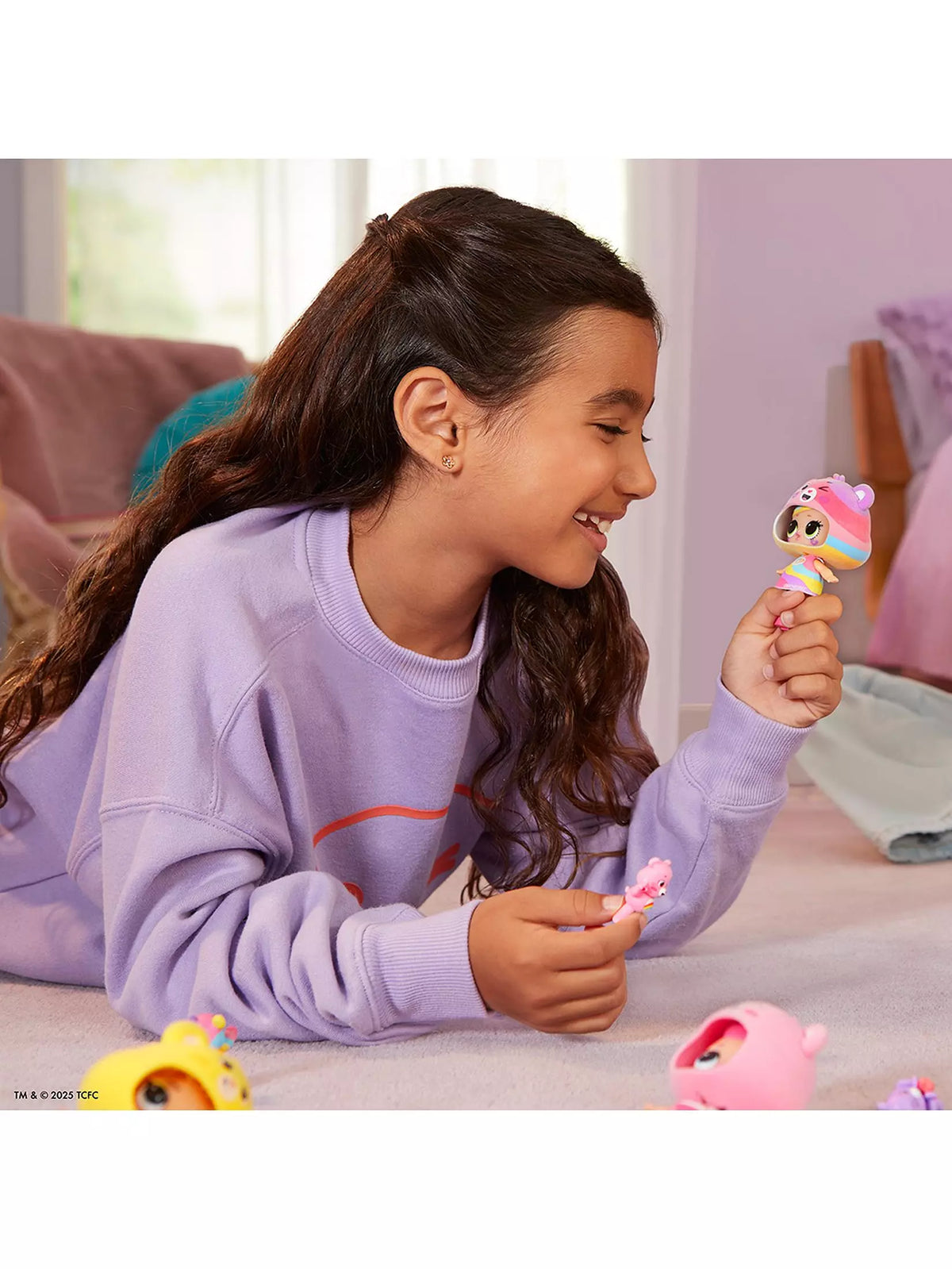 girl holding carebear doll