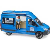 model campervan with door open and figurine drinking coffee 