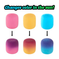 pink, orange and blue squishy balls slowly changing to darker colours 