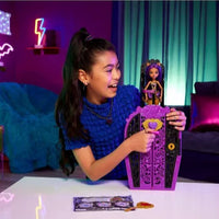 girl smiling and playing with wolf girl doll and purple wardrobe 