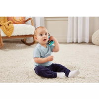 baby boy holding baby phone 