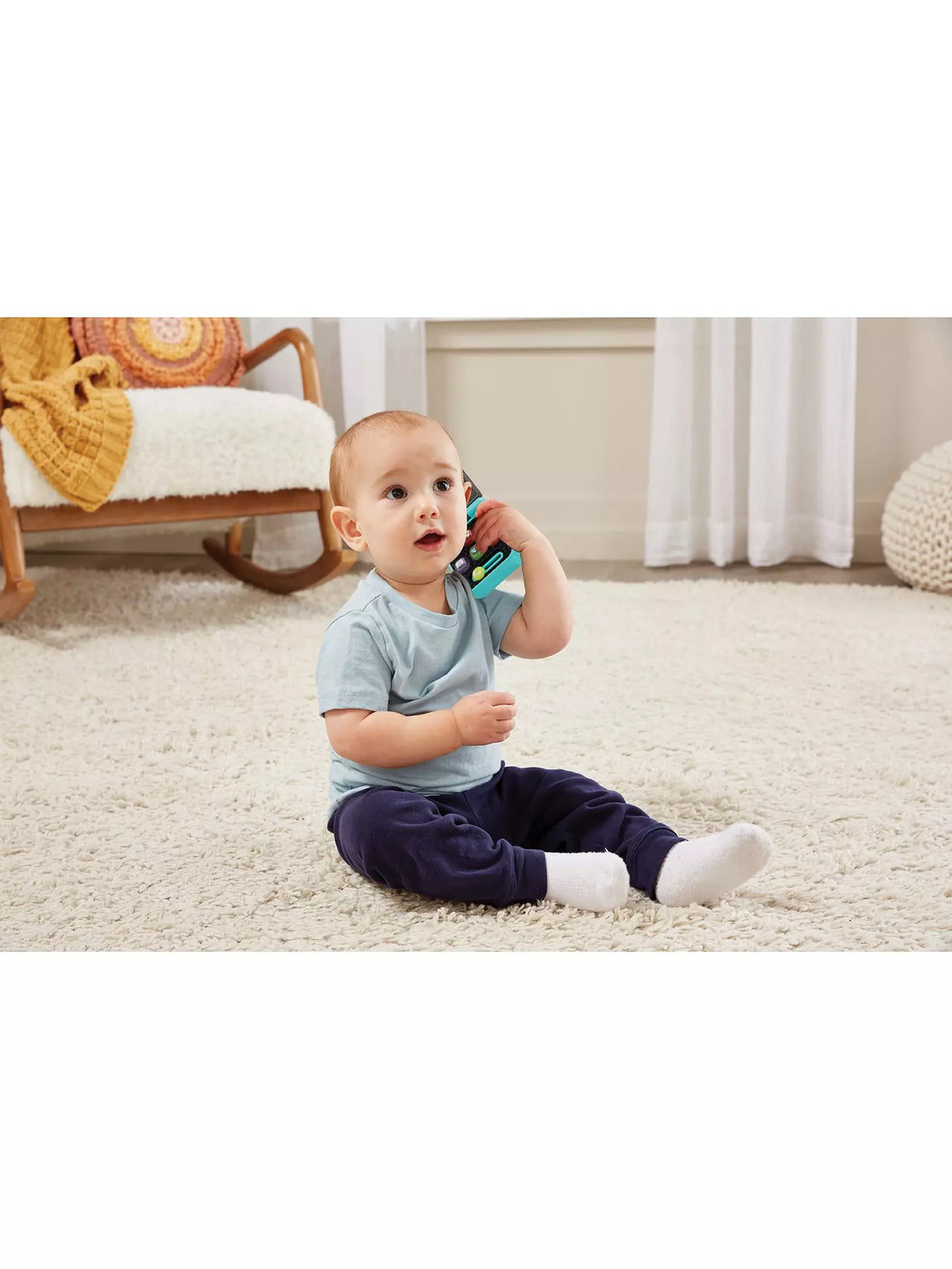 baby boy holding baby phone 