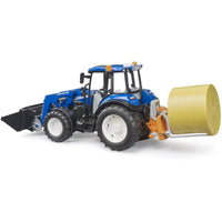 blue tractor with bale on the back 