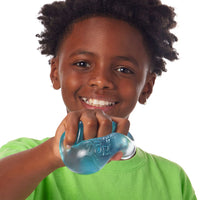 young boy squishing blue squishy cube on white background