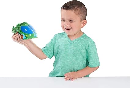 young bpy holding right green and blue toy car