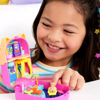 young girl playing with brightly coloured kitty compact and smiling 