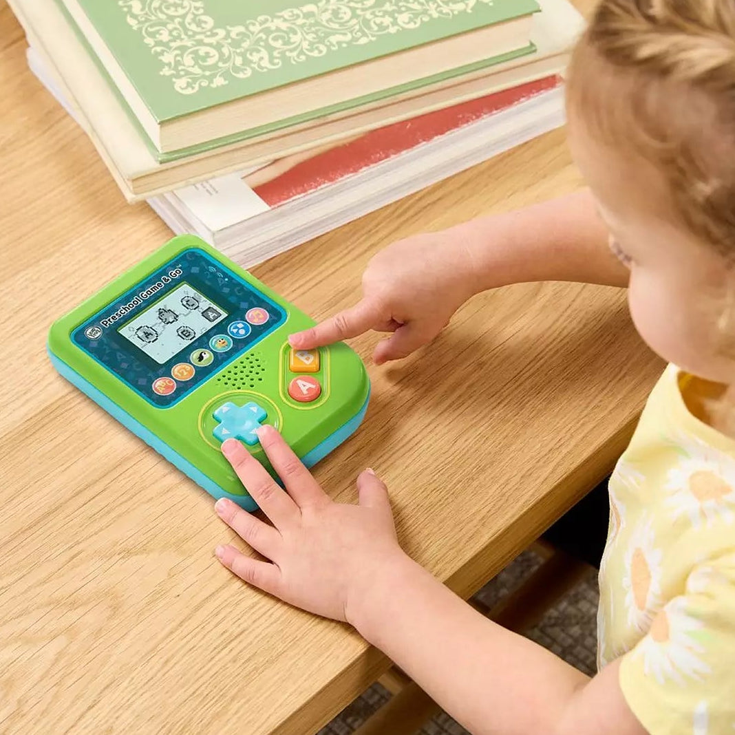 child playing with preschool gaming console 