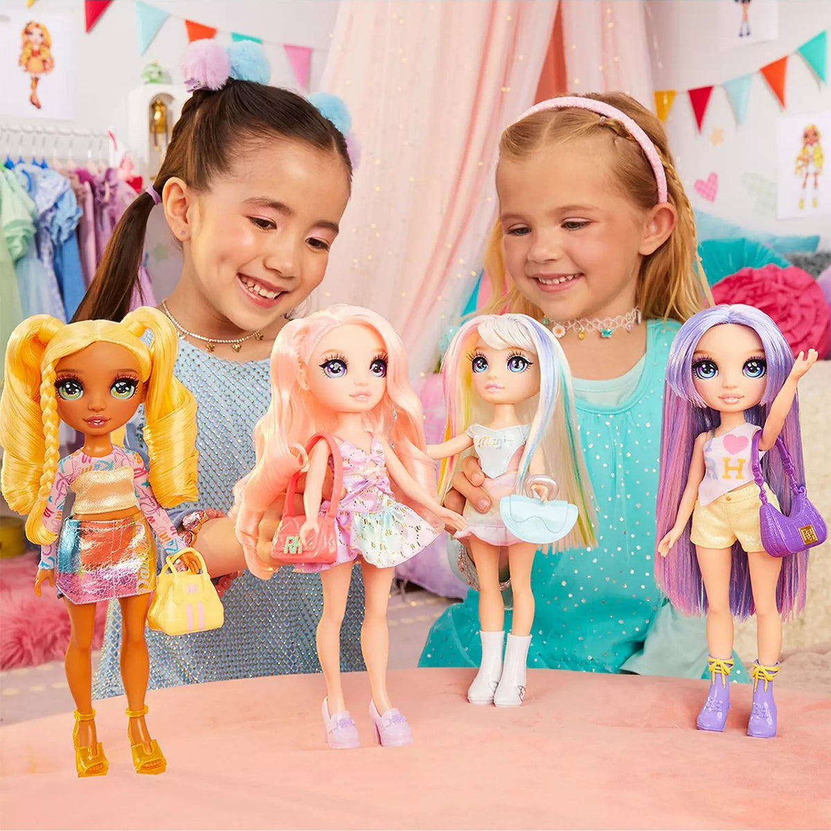 girls playing with rainbow fashion dolls 