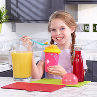 girl using pink slushy maker cup 