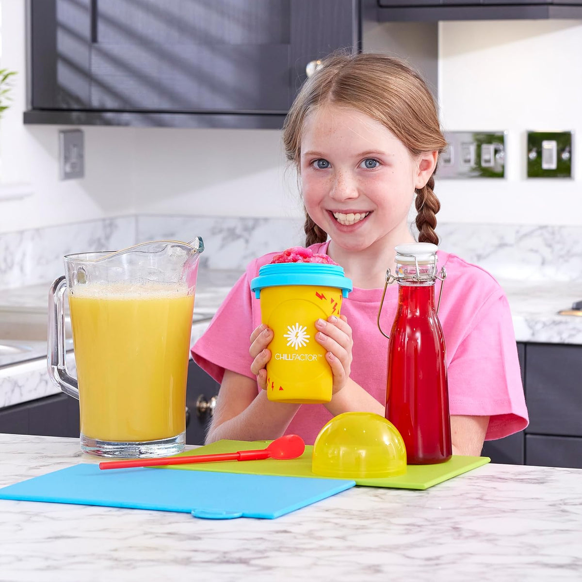 girl using yellow slushy maker cup 