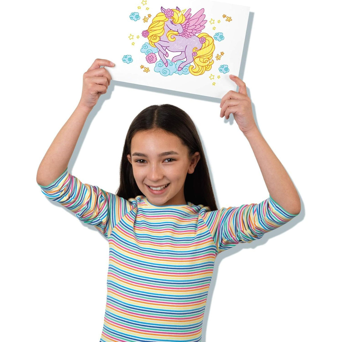girl holding up unicorn drawing 