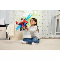 young girl in bedroom playing with red dinosaur with blue wings 
