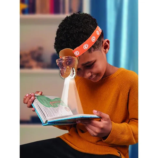 boy using dinosaur head torch 