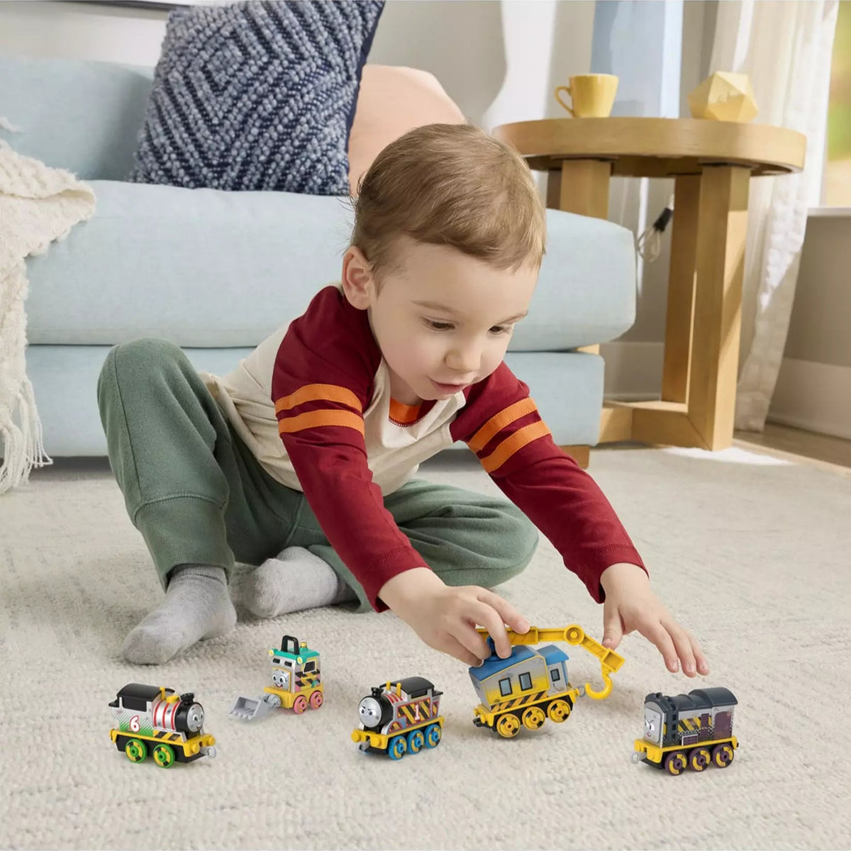 toddler playing with trains 
