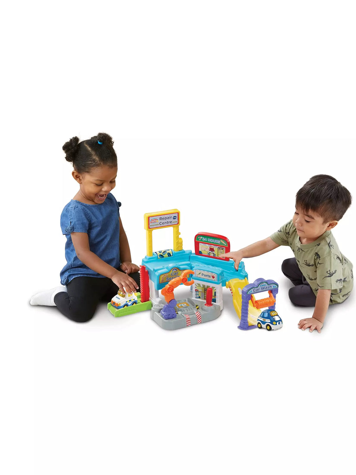 two toddlers playing with colourful driver repair playset on white background 