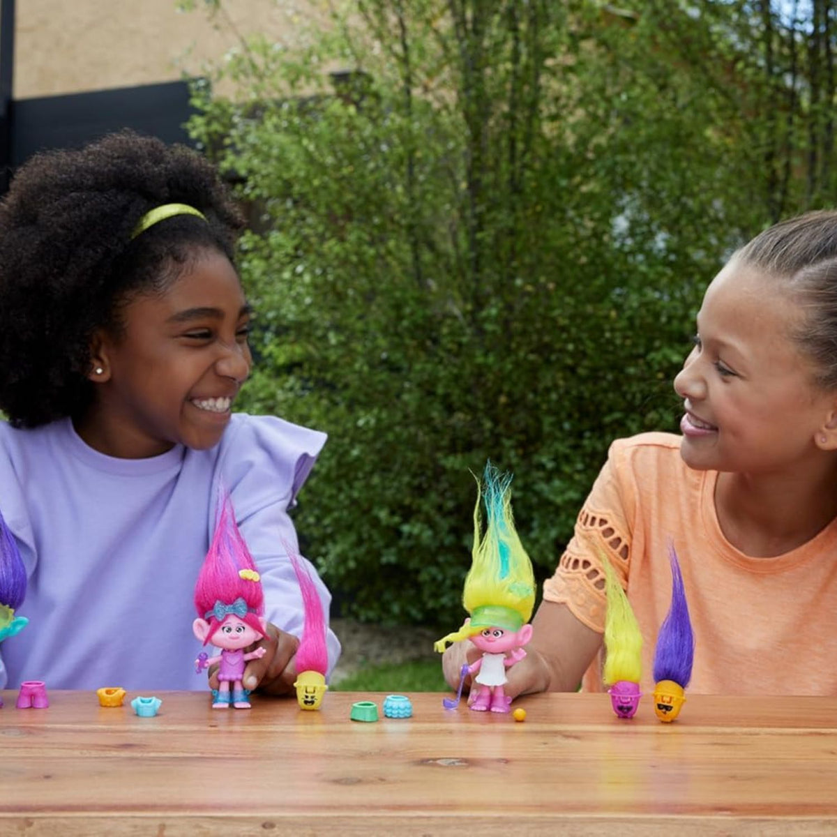 girls playing with trolls dolls 
