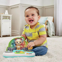 baby playing with brightly coloured children's toy on carpet 