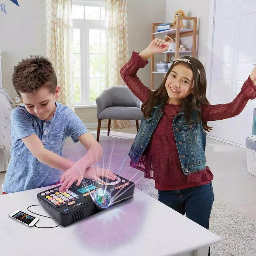 two children playing with DJ mixtable in living room 