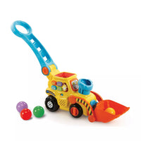 Toys plastic digger and balls on white background 
