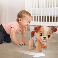 baby playing with plush interactive puppy 