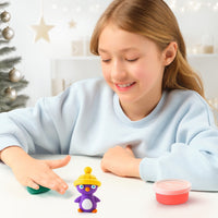 girl making purple clay penguin 