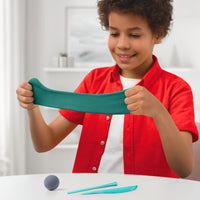 boy stretching green clay 