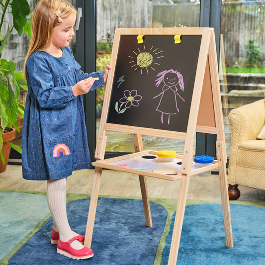 girl playing with wooden easel