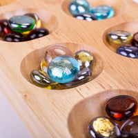 close up of marble of wooden mancala game