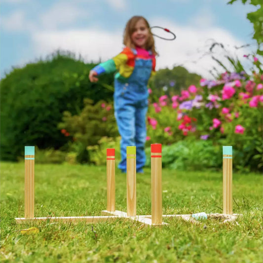 child playing wooden ring toss game