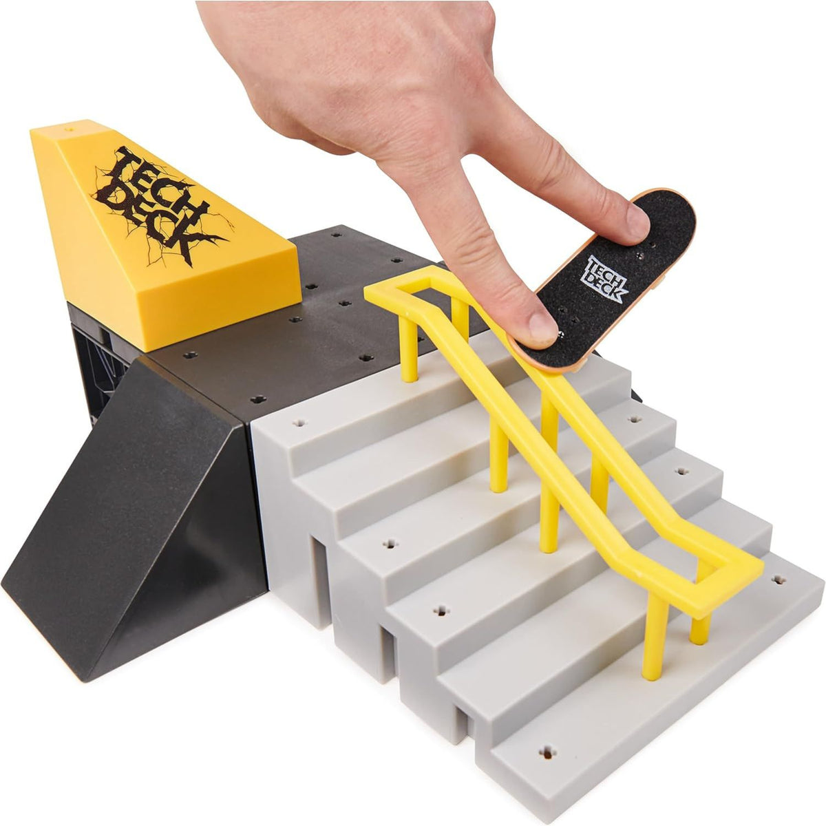 hand playing with tech deck set 