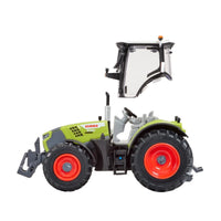 Side view of the Britain's CLAAS Arion 6.190 toy tractor with removable cab, detailed operator controls, and white studio background.