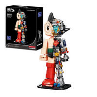 Toy figure of Astro Boy next to its packaging on a white background