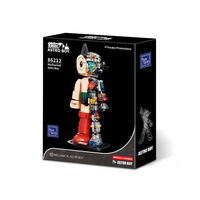 Boxed toy figure of Astro Boy with branding and product details on a white background