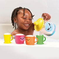 Child pouring bubbly water from the Tomy Bubble & Brew Bath Set teapot into colourful cups.