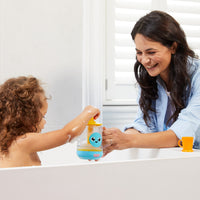 Child using the Tomy Bubble & Brew Bath Set teapot with mother to make bubbles during bath time.