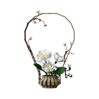 Features a freestanding floral arrangement in a decorative pot