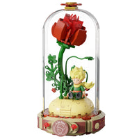Features The Little Prince seated on a small planet with floral details
